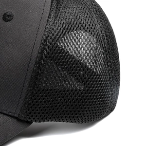 Close-up of breathable mesh texture and premium stitching on a black trucker hat