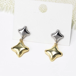 Detail showing gold and silver interlocking four-point star earrings on white display