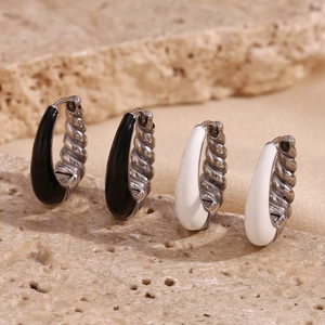 Macro detail of 18K gold plated drop oil hoop earrings with spiral texture on stone