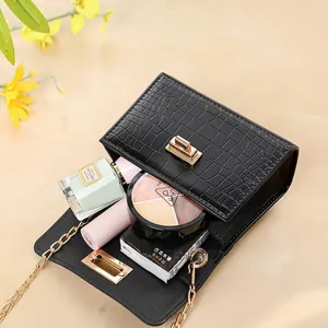 Black crocodile embossed PVC jelly bag with gold chain strap and pearl handle detail