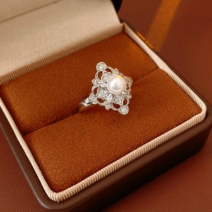 Detailed macro view of vintage silver ring with pearl and cubic zirconia in velvet box