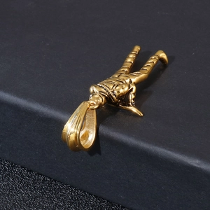 Detail of golden soldier pendant showing the engraved Stainless Steel mark on the bail