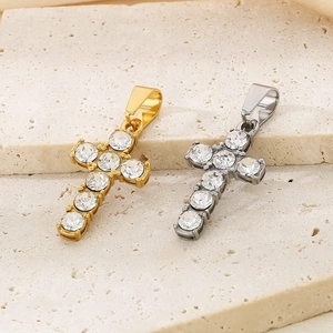 Macro view of gold and silver cross pendants featuring brilliant round rhinestones