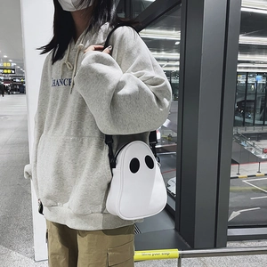 Detail of cute white ghost shoulder bag with black zip closure and adjustable strap