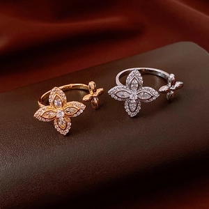Detailed close-up of gold and silver flower rings with sparkling zircon crystals