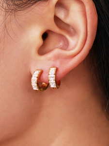Macro shot of 18k gold plated hoop earrings with channel set square cubic zirconia