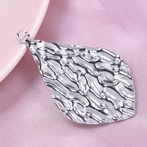 Macro shot of silver 304 stainless steel oval leaf pendant with water ripple texture