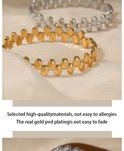 Detailed close-up of gold and silver stainless steel dot bracelets with PVD plating