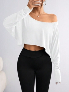 Detail view of off-shoulder long sleeve crop top in white with soft fabric texture