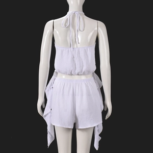 Detailed back view of white two-piece set featuring halter top and fringed shorts texture