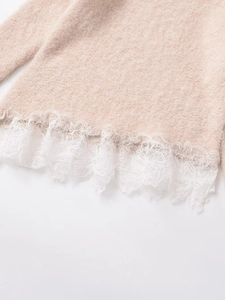 Close-up of soft pink knit sweater with delicate white floral lace hem detailing