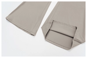 Detail of double-needle stitching and inner hem on khaki flared yoga jumpsuit pants