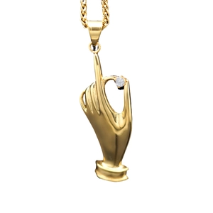 Gold stainless steel hand gesture pendant with sparkling stone on a white background