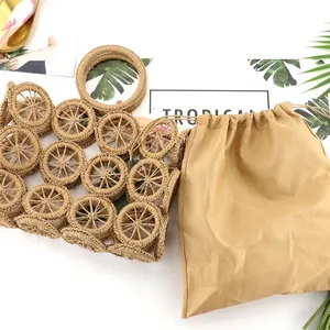 Handcrafted circular hollow woven straw handbag with a practical khaki drawstring inner bag