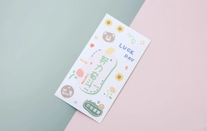 Detail of cute PVC cartoon stickers with inspirational text on a diagonal pastel background