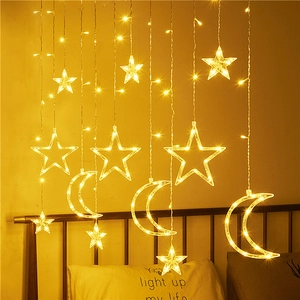 Warm yellow star and moon LED curtain string lights for cozy indoor home decoration