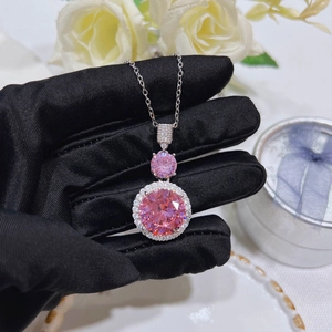 Detailed close-up of pink zircon pendant necklace with silver chain and halo setting