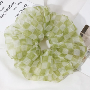 Detail of light green checkerboard organza scrunchie with sheer fabric texture