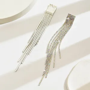 Detailed macro view of cascading multi-row rhinestone fringe earrings in silver and rainbow colors