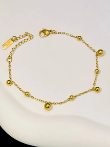 Close-up of 18K gold plated stainless steel chain necklace with polished bead charms