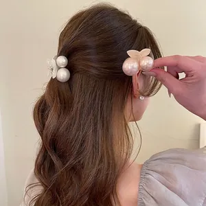 Elegant cherry pearl hair claw clips for women showing side hair styling on a model