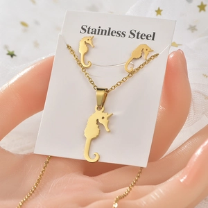 Detailed view of golden stainless steel seahorse pendant necklace and earring set