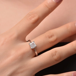Detailed view of square cut cubic zirconia ring set in silver on woman's finger