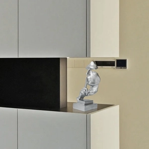 Modern silver Silence is Gold abstract human face sculpture on a square base for office decor