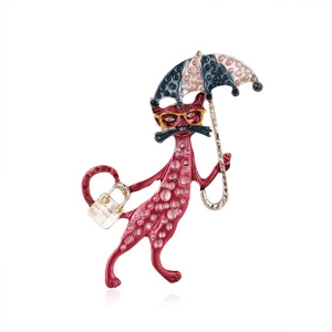 Detail of whimsical red cat brooch with yellow glasses and a blue patterned umbrella