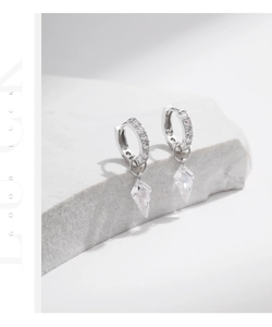 Close-up of S925 sterling silver hoop earrings with sparkling geometric crystal pendants
