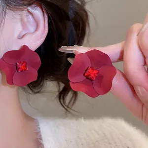 Elegant red matte flower earrings with square crystal centerpiece for a retro luxury look