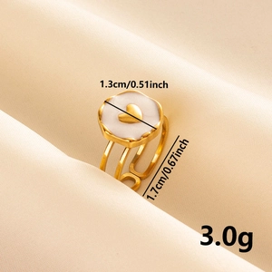 Detailed view of white petal ring with gold heart and dimension measurements