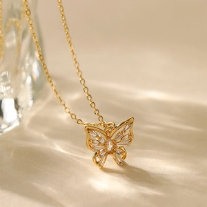 Close-up of gold-plated butterfly pendant with sparkling zircons on a luxury necklace