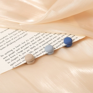 Three-piece macaron magnetic clips for scarves and clothes on champagne satin fabric