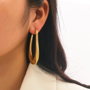 Elegant gold U-shaped drop earrings with high-polish mirror finish in minimalist style