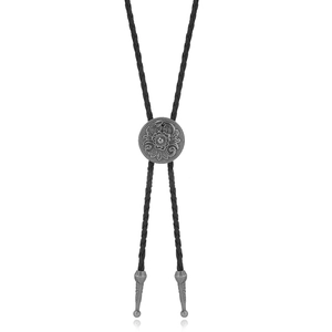 Detailed view of vintage silver floral embossed bolo tie buckle and metal tips