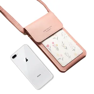 Pink faux leather touchscreen phone bag with floral pattern and crossbody strap