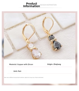 Macro detail of cat earrings featuring gold-plated copper and sparkling zircon stones