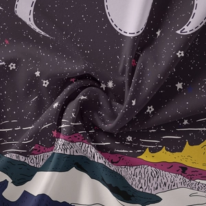 Close-up of bohemian tapestry showing soft fabric texture and starry mountain print