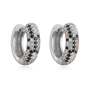 Detailed macro view of silver hoop earrings with pave-set black and champagne gemstones
