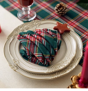 Macro view of Christmas tree folded cloth napkin in red and green check pattern