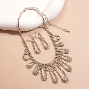 Detailed close-up of a silver fringe necklace set with sparkling rhinestones on a tray