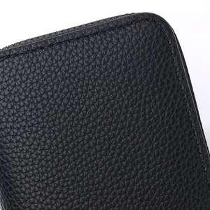 Close-up of black pebble leather card holder showing stitching and zipper details