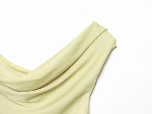 Close-up of asymmetrical draped shoulder detail on a silky sage green slim-fit top