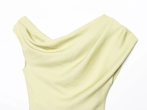 Detail shot of the pleated asymmetrical neckline on the light yellow slim-fit top