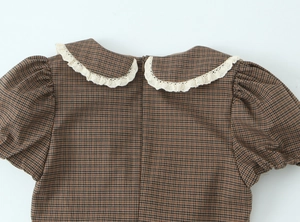 Detailed back view of a plaid dress featuring a hidden zipper and white lace collar