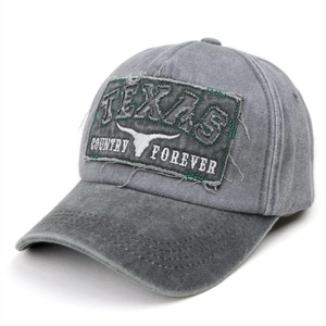 Detailed close-up of embroidered Texas patch on washed grey vintage baseball cap