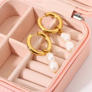 Detail view of 18K gold plated thick hoop earrings with double white baroque pearls