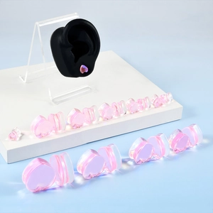 Pink heart-shaped glass ear plugs gauges jewelry displayed in multiple sizes
