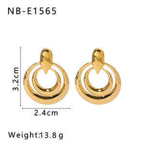 Detail view of stacked gold geometric earrings with dimensions 3.2cm by 2.4cm